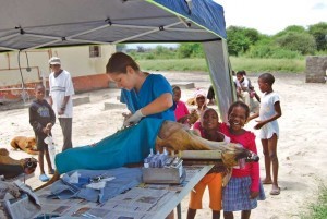 Children watch a surgical procedure at an outreach clinic in Sehitwa, Botswana.