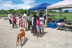 Locals wait for their animals to receive treatment at an outreach clinic in Sehitwa, Botswana.