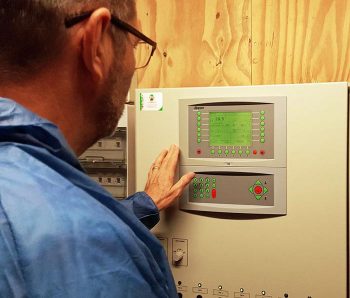 Reviewing computer settings in controlled environment housing.
