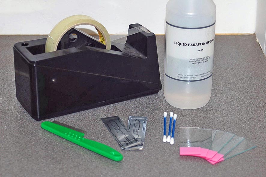 Figure 9. Dermatological sampling kit comprising a flea comb, scalpel blades, glass slides, clear sticky tape, cotton buds and liquid paraffin.
