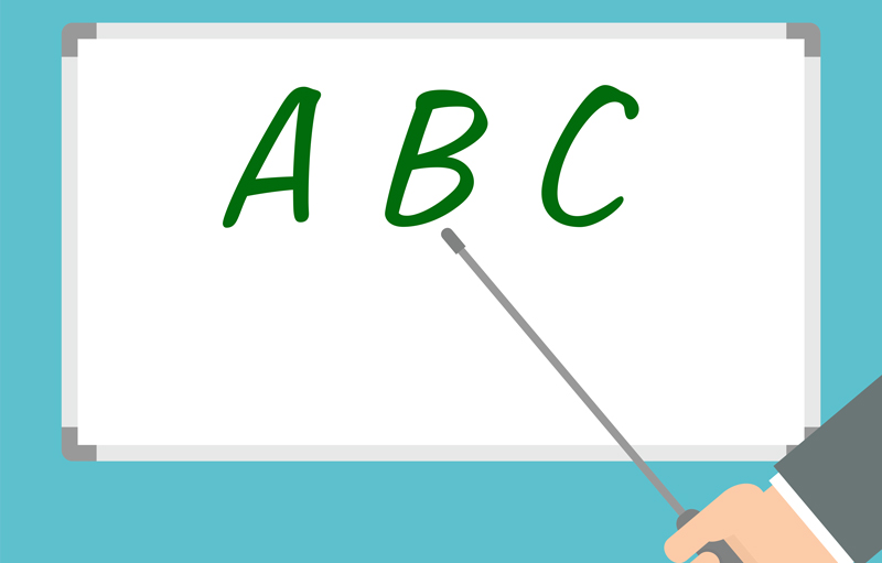 Whiteboard with pointer and ABC.