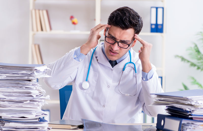 Stressed vet with paperwork.