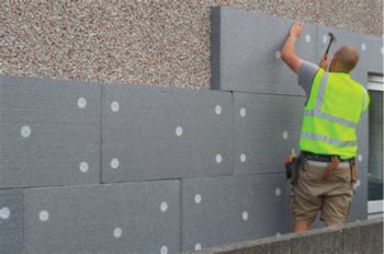 Expanded polystyrene external insulation being fitted. This is usually rendered to create a weatherproof finish.